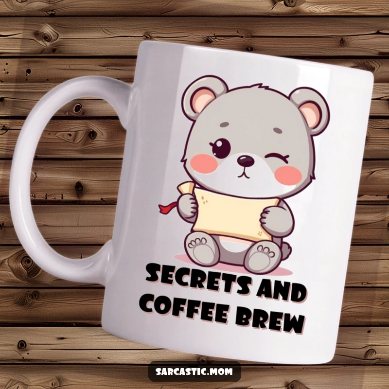 Funny cute bear cub with a knowing wink holding a tiny rolled-up scroll on a mug, perfect for mystery lovers.