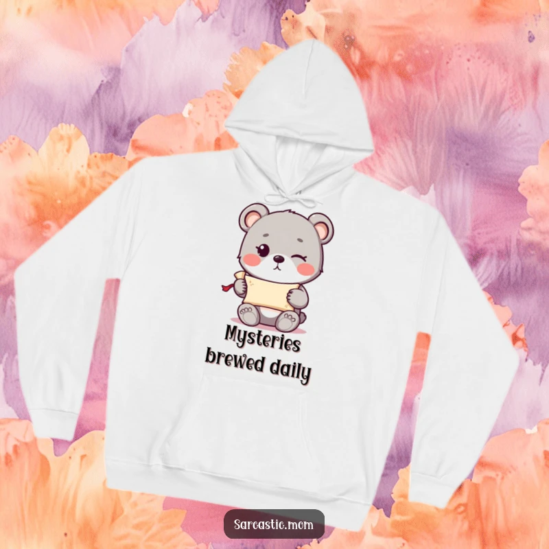 Funny cute bear cub with a knowing wink holding a tiny rolled-up scroll, printed on a warm hoodie.