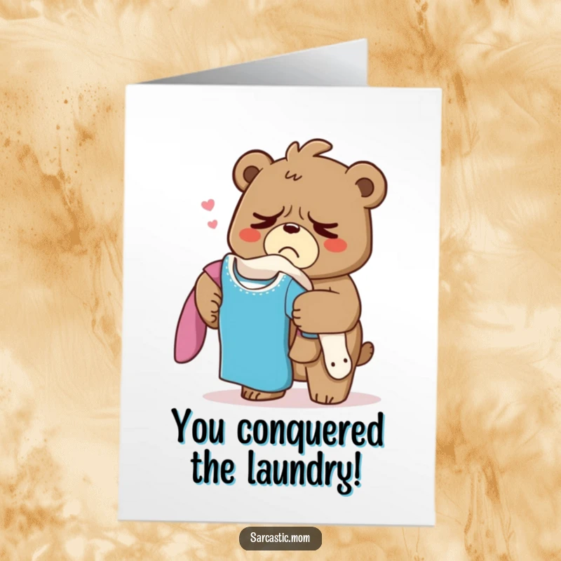 Funny Free Printable Congratulations Card: Grumpy bear mom sighing while holding a pile of laundry, celebrating an accomplishment.